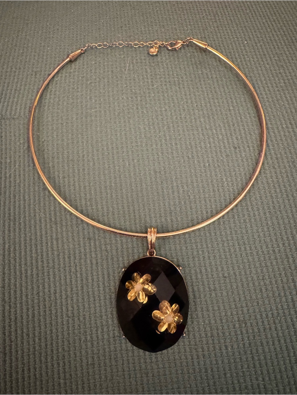 Gold-Tone Choker Necklace with Black Oval Pendant and Gold Flower Accents